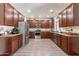 Modern kitchen boasting stainless steel appliances, dark wood cabinets, and ample counter space at 5445 S 239Th Dr, Buckeye, AZ 85326
