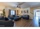Cozy living room featuring wood-look floors, ceiling fan, and neutral paint at 5445 S 239Th Dr, Buckeye, AZ 85326