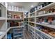 Walk-in pantry with organized shelving and ample storage space for food and appliances at 5445 S 239Th Dr, Buckeye, AZ 85326