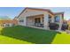 Beautiful backyard featuring an inviting covered patio and a lush lawn, ideal for outdoor enjoyment at 7442 W Redbird Rd, Peoria, AZ 85383