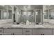 Modern bathroom with dual vanities, stylish mirrors, and glass enclosed shower at 7442 W Redbird Rd, Peoria, AZ 85383