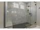 Stunning shower with light tilework, bench seating and dark mosaic tile flooring at 7442 W Redbird Rd, Peoria, AZ 85383