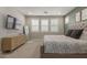Comfortable bedroom with sleek TV, neutral colors, and bright window light at 7442 W Redbird Rd, Peoria, AZ 85383