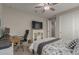 Cozy bedroom featuring a ceiling fan, media center, and home office desk with executive chair at 7442 W Redbird Rd, Peoria, AZ 85383