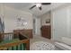Well-appointed Bedroom featuring a crib, dresser, and forest-themed wall decor at 7442 W Redbird Rd, Peoria, AZ 85383