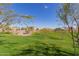 Beautiful view of the community park featuring lush green lawns, desert landscaping, and well-maintained walking paths and neighborhood homes at 7442 W Redbird Rd, Peoria, AZ 85383