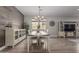 Dining room features a modern chandelier, stylish decor, and hardwood floors at 7442 W Redbird Rd, Peoria, AZ 85383