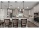 Modern kitchen featuring stainless steel appliances, white quartz countertops, and a large island at 7442 W Redbird Rd, Peoria, AZ 85383