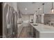 Gourmet kitchen with a large island, stainless steel appliances, and modern finishes at 7442 W Redbird Rd, Peoria, AZ 85383