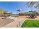 Community playground with play structures and sunshades, surrounded by lush landscaping and walkways at 7442 W Redbird Rd, Peoria, AZ 85383