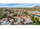 Aerial view of a residential neighborhood with lush greenery, a canal, and mountain views in the distance at 7800 E Lincoln Dr # 1104, Scottsdale, AZ 85250