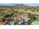 Scenic aerial view of luxury townhomes with a canal running through the community and mountain views in the background at 7800 E Lincoln Dr # 1104, Scottsdale, AZ 85250