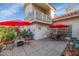 Back patio with tile flooring, seating, and potted plants at 7800 E Lincoln Dr # 1104, Scottsdale, AZ 85250