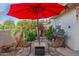 Back patio with seating, a grill, and beautiful landscaped plants at 7800 E Lincoln Dr # 1104, Scottsdale, AZ 85250