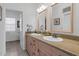 Bright bathroom featuring double sinks, ample counter space, and a doorway to another room at 7800 E Lincoln Dr # 1104, Scottsdale, AZ 85250