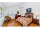 Inviting main bedroom with ceiling fan, hardwood floors, and comfortable furnishings at 7800 E Lincoln Dr # 1104, Scottsdale, AZ 85250