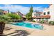 Community swimming pool surrounded by lounge chairs and verdant trees, perfect for relaxation at 7800 E Lincoln Dr # 1104, Scottsdale, AZ 85250