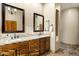 Double vanity sink with granite countertop and wood cabinets in this bathroom at 8540 E Mcdowell Rd # 19, Mesa, AZ 85207