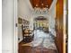 Grand foyer featuring terracotta tile, wood beam ceiling, chandelier, and an open view to the living room and backyard at 8540 E Mcdowell Rd # 19, Mesa, AZ 85207