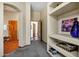 Inviting hallway featuring an arched entry, Saltillo tile flooring, neutral paint, and carpet beyond at 8540 E Mcdowell Rd # 19, Mesa, AZ 85207