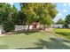 Backyard features a custom putting green, mature trees, and manicured landscaping at 9159 N 108Th Pl, Scottsdale, AZ 85259
