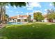 Beautiful backyard featuring a pool, a manicured lawn, and resort-style landscaping at 9159 N 108Th Pl, Scottsdale, AZ 85259