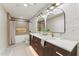 Modern bathroom featuring double sinks, stylish mirrors, and a luxurious shower and tub at 9159 N 108Th Pl, Scottsdale, AZ 85259