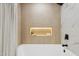 Close-up of the tiled shower and tub area, accented by a built-in niche at 9159 N 108Th Pl, Scottsdale, AZ 85259