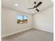 Carpeted bedroom boasts a ceiling fan, neutral paint, and a view of the neighborhood at 9159 N 108Th Pl, Scottsdale, AZ 85259