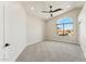 Spacious bedroom with a vaulted ceiling, a large arched window, and neutral color palette at 9159 N 108Th Pl, Scottsdale, AZ 85259