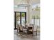 Bright dining room with modern light fixture, table with six chairs, and views to a colorful backyard at 9159 N 108Th Pl, Scottsdale, AZ 85259