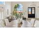 Open concept dining room with high ceilings, statement window and modern table with seating for six at 9159 N 108Th Pl, Scottsdale, AZ 85259