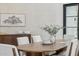 Dining room with textured wallpaper, a dark wood console, and a table set for six with olive branch centerpiece at 9159 N 108Th Pl, Scottsdale, AZ 85259