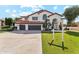 Two-story home showcasing a tile roof, three-car garage, arched entryway, and verdant lawn with a real estate sign at 9159 N 108Th Pl, Scottsdale, AZ 85259