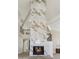 Grand living area showcasing a floor-to-ceiling fireplace, high ceilings, hardwood floors, and modern staircase at 9159 N 108Th Pl, Scottsdale, AZ 85259