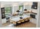 Open gourmet kitchen with a large center island, sleek cabinetry, and modern pendant lighting at 9159 N 108Th Pl, Scottsdale, AZ 85259