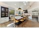 Modern eat-in kitchen with an oversized island, stylish barstool seating and sleek pendant lighting at 9159 N 108Th Pl, Scottsdale, AZ 85259