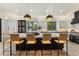 Stylish kitchen featuring a large center island with seating, contrasting cabinetry, and modern lighting at 9159 N 108Th Pl, Scottsdale, AZ 85259