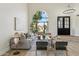 Bright living room with a soaring arch window, hardwood floors, contemporary furnishings, and stylish lighting at 9159 N 108Th Pl, Scottsdale, AZ 85259