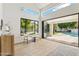 Bright living room with vaulted ceilings and sliding doors to the pool area at 9159 N 108Th Pl, Scottsdale, AZ 85259