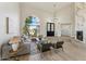Bright living room with a soaring arch window, hardwood floors, contemporary furnishings, and stylish lighting at 9159 N 108Th Pl, Scottsdale, AZ 85259