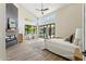 Bright main bedroom with vaulted ceiling, dark fireplace, and large sliding glass doors to the backyard at 9159 N 108Th Pl, Scottsdale, AZ 85259