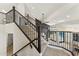 Elegant staircase with dark wood railing, carpeted steps, and views of the pool and backyard at 9159 N 108Th Pl, Scottsdale, AZ 85259