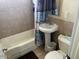 Bathroom with a shower-tub combination, tile surround, pedestal sink and toilet at 9804 N 5Th Ave, Phoenix, AZ 85021