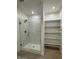 Contemporary bathroom features a sleek glass shower and open shelving, maximizing space and style at 10039 S 23Rd Dr, Phoenix, AZ 85041