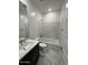 Modern bathroom showcasing a vanity with sink and a bathtub with tiled surround at 10039 S 23Rd Dr, Phoenix, AZ 85041