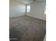 View of a carpeted bedroom with natural light from two windows, offering a serene and comfortable space at 10039 S 23Rd Dr, Phoenix, AZ 85041