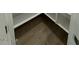 Walk-in closet features stylish chevron flooring and ample storage space with white shelving at 10039 S 23Rd Dr, Phoenix, AZ 85041