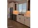 Bright kitchen features stainless steel appliances, modern sink and bright white cabinets at 10039 S 23Rd Dr, Phoenix, AZ 85041