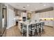 Spacious kitchen with white cabinetry, a large island with seating, and modern stainless steel appliances at 10039 S 23Rd Dr, Phoenix, AZ 85041